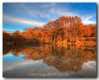 Sunset turns the cypress a brilliant orange at Pedernales Falls State park in the Texas Hill Country