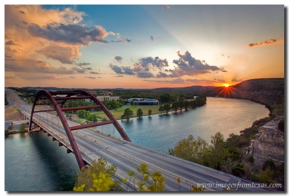 The sun sets in the west and lights up the skies over Pennybacker Bridge and Austin, Texas.