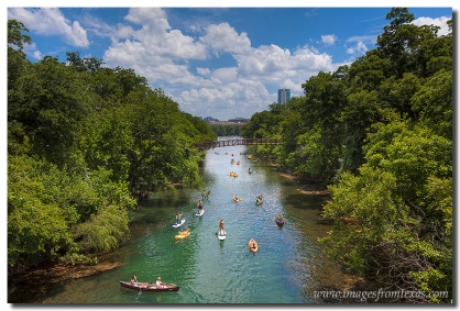 Austinites enjoy the cool waters of Lady Bird Lake in Austin Texas on a summer afternoon.