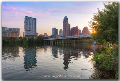 The Austin skyline is visible from along the Hike and Bike trail at Zilker Park.